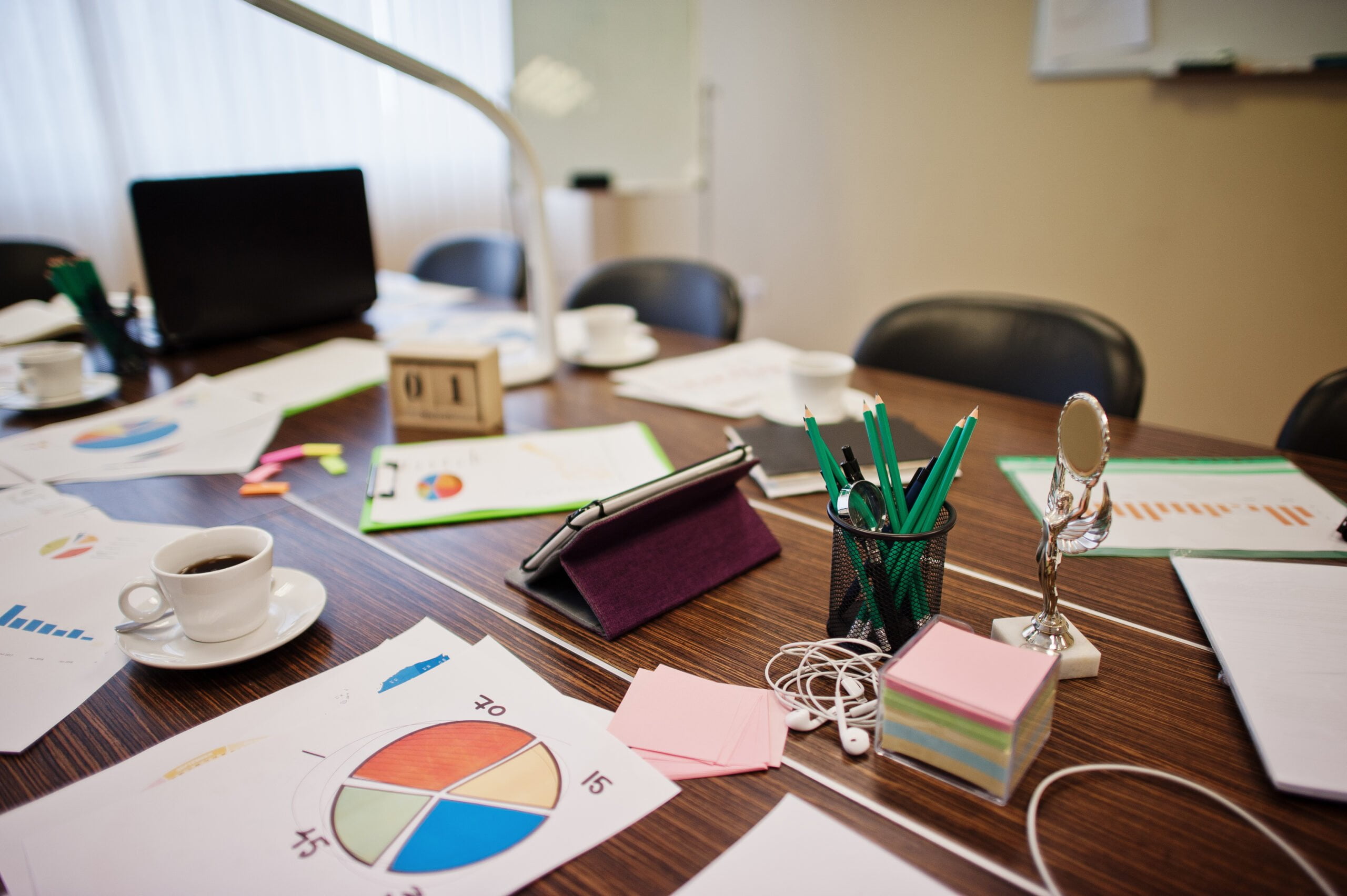 Modern creative workplace with laptop, tablet, equipment and table led lamp. Office design concept with graphics.